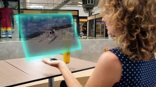 Woman Watching Video on Futuristic Media Device