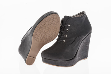 platform shoes made of black leather with laces on white background