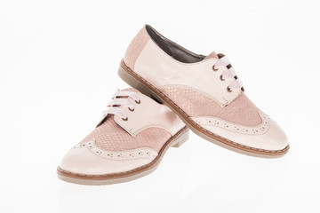  shoe made of pink leather with laces for women on white background