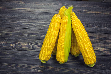 corn on the cob on a wooden table