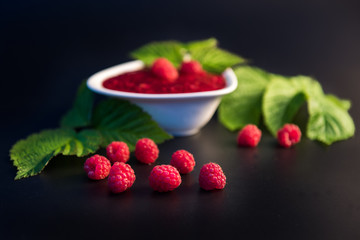 Raspberries jam with berries and leavies