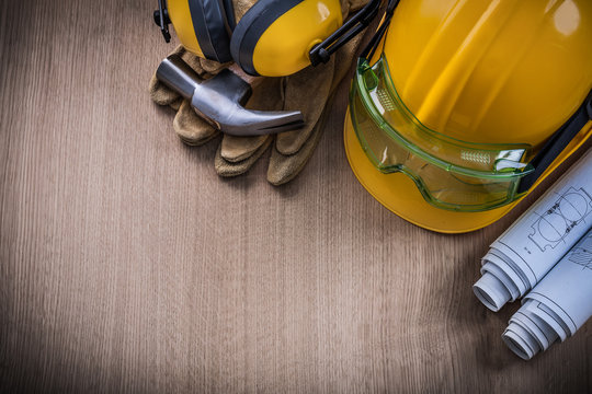 Hammer safety glasses blueprints protective gloves hard hat earm