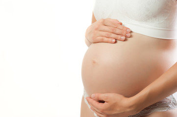 Belly of a pregnant woman close up isolated on white background