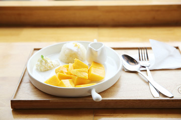 Sticky Rice with Mango on wood background