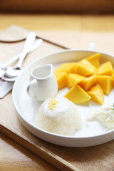 Sticky Rice with Mango on wood background