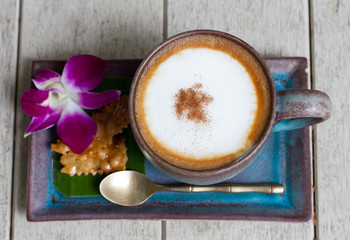 A cup of coffee cappucino wooden background