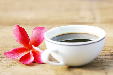 Coffee and frangipani on wooden table 