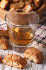 almond biscotti biscuits and sweet wine in a glass closeup. vertical
