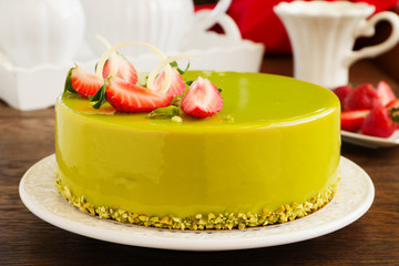 Delicious strawberry-pistachio mousse cake with a smooth glaze.