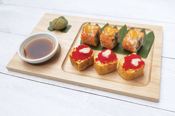 Colorful sushi on wooden tray
