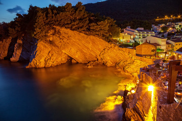Night scene with cliff on the Adriatic sea coast in Petrovac, Montenegro. 