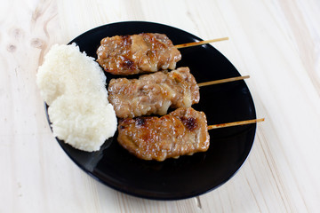 Thai-styled grilled pork and sticky rice. It's among most popular street foods in Thailand.
