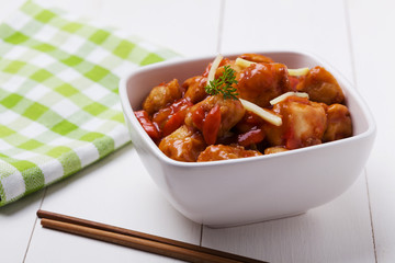 Fried chicken pieces in batter with sweet and sour sauce