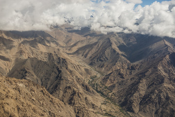 Aerial view of desert and high mountain from the airplane window. New Delhi-Leh flight ,India.