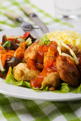 Fried chicken pieces in batter with sweet and sour sauce