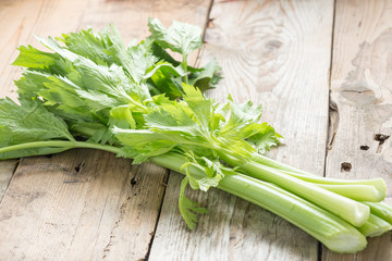 Fresh celery on wood background.