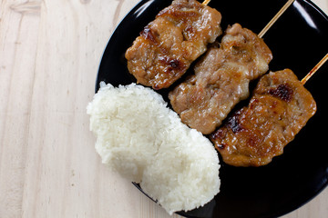 Thai-styled grilled pork and sticky rice. It's among most popular street foods in Thailand.