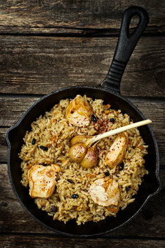 pilaf in a pig-iron frying pan