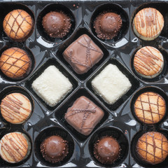 Assorted chocolate in a box. Top view.