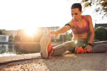 Photo sur Plexiglas Jogging Fitness woman stretching before a run