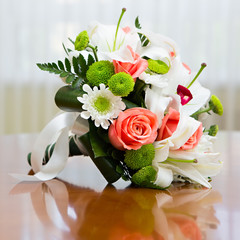 Wedding bouquet of roses and lilies for bride at a wedding party