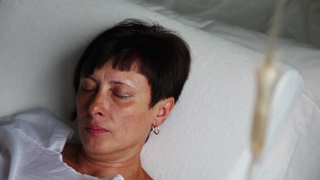 Patient in hospital bed recieving infusion therapy