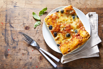 healthy slice of Italian pizza on a plate on a wooden background