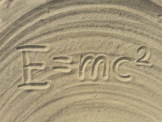 Fototapeta na wymiar einstein formula on the sand E mc2