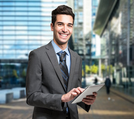 Businessman using his tablet in a business environment