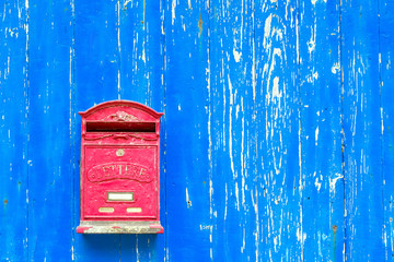 red mail box on textured wall