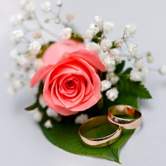 Gold wedding rings on a bouquet of flowers for the bride