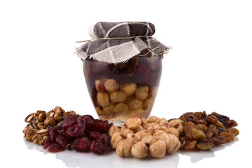 Honey in jar with dried fruits
