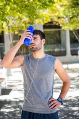 Exhausted runner putting a water bottle on head