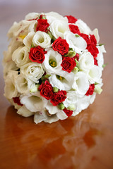 Wedding bouquet of roses and lilies for bride at a wedding party