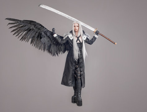 Fantasy woman warrior / Woman warrior with sword and wings isolated on the gray background
