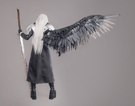 Fantasy woman warrior / Woman warrior with sword and wings isolated on the gray background