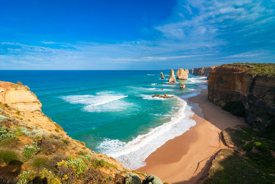 The landmark Twelve Apostles along the famous Great Ocean Road, Victoria, Australia with wide sandy beach at the base of cliffs in the foreground