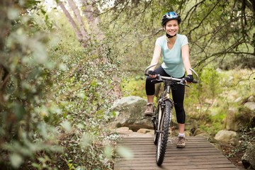 Fototapeta na wymiar Smiling fit woman taking a break on her bike