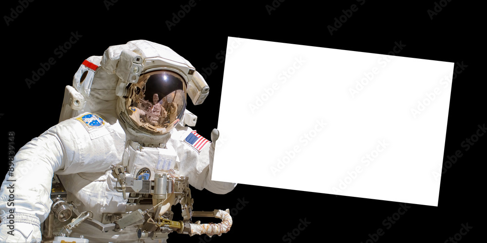 Wall mural astronaut in space holding a white blank sign with copy space - elements of this image are provided 