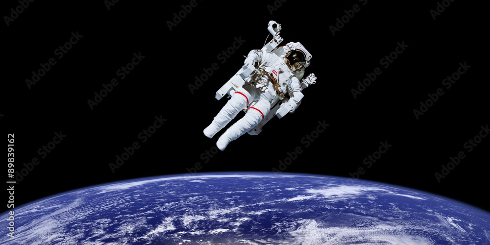 Wall mural astronaut in outer space over the planet earth. elements of this image furnished by nasa