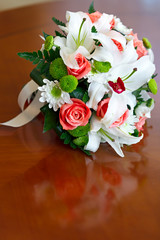 Wedding bouquet of roses and lilies for bride at a wedding party