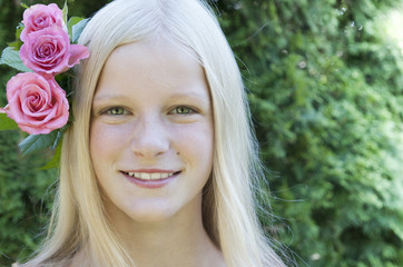Scandinavian blonde girl with roses in her hair