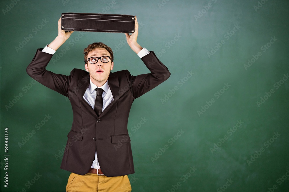 Canvas Prints Composite image of young geeky businessman holding briefcase