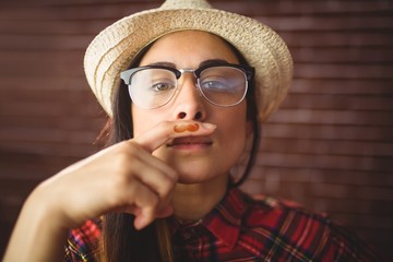 Beautiful hipster with mustache on finger