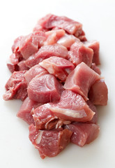 Cut a piece of fresh meat for cooking.