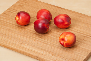 Fresh Nectarine Fruits On Wooden Board