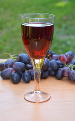 Бокал красного вина и винограда