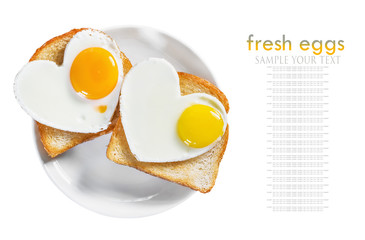 Two toast with scrambled eggs in the shape of a heart