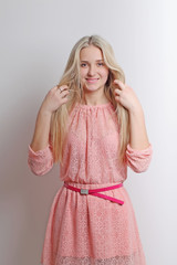 Portrait of young woman on white background, touching her lovely