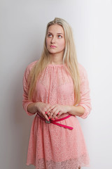 Sensual blonde woman in elegant dress looking up